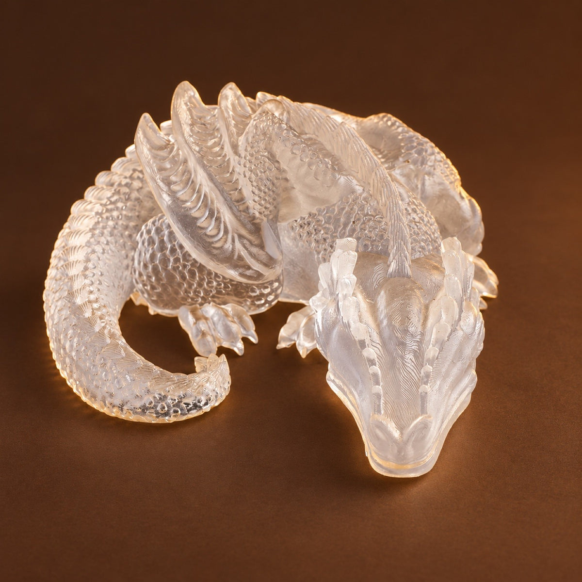 Clear resin sleeping dragon figurine with gold flakes, no stones